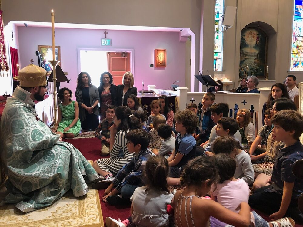 Young children seated at the front of the sanctuary during a church gathering.