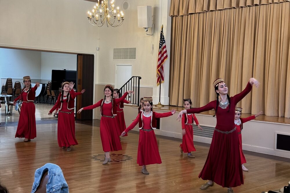 Armenian folk dancers performing in the church hall.