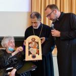 Yn. Betty Sempadian receives an icon of Jesus Christ from Archbishop Hovnan Derderian and Fr. Mesrop Ash