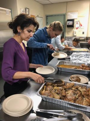 Parish volunteers portion meals in the kitchen during a past Winter Shelter service.