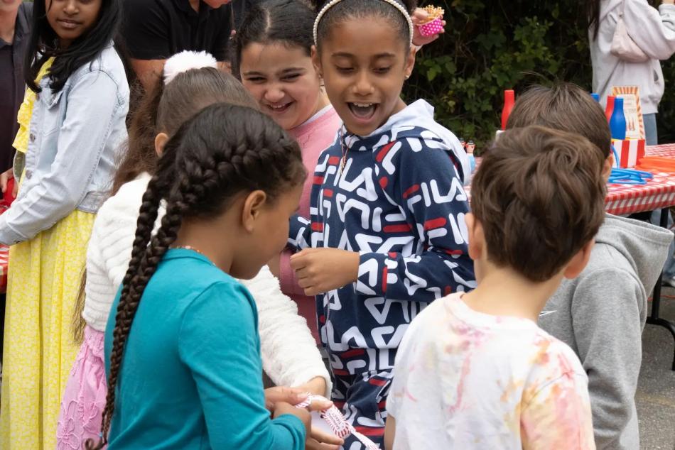 Children enjoy an ACYO fundraiser game booth