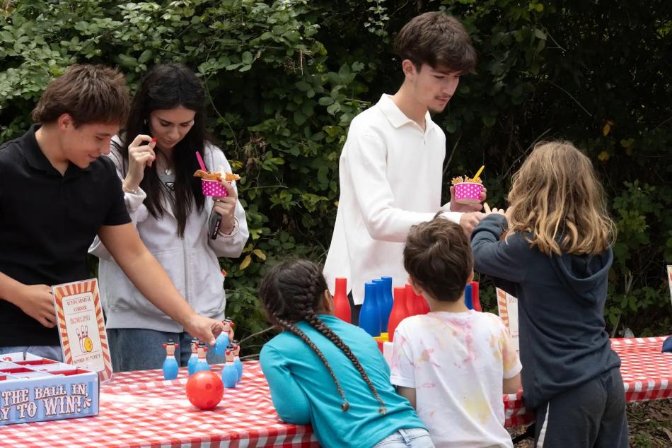 ACYO volunteers and children play a bowling game at the parish picnic
