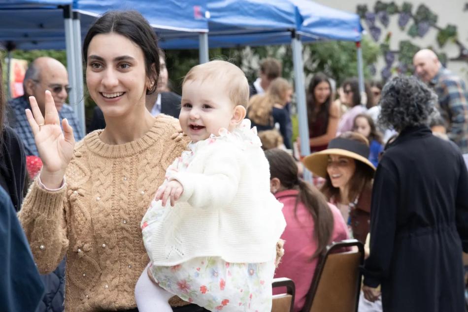 An ACYO member and child join the St. John parish picnic