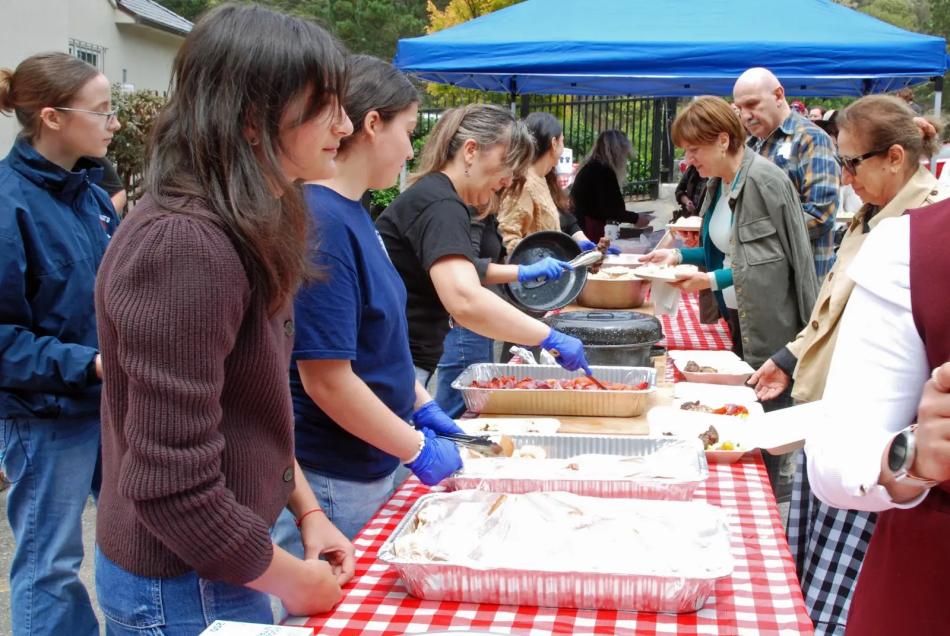 Volunteers serve kebab and food at the parish picnic