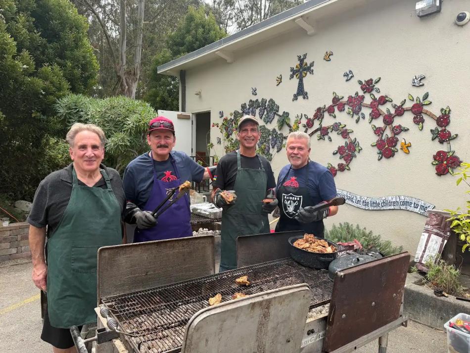 Volunteers prepare barbecue for the St. John parish picnic