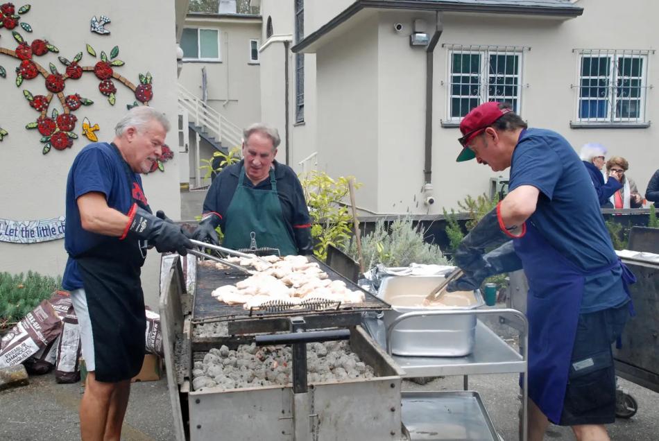 Volunteers prepare kebab at the St. John parish picnic