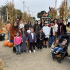 Children and adults pose together among pumpkins and tall cornstalks at Clancy’s Pumpkin Patch.