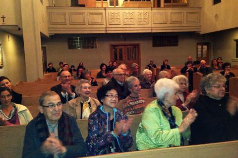 Concert goers applaud the moving performance. Concert goers applaud the moving performance.